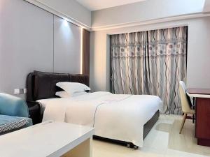 Ein Bett oder Betten in einem Zimmer der Unterkunft 广州沃家国际公寓