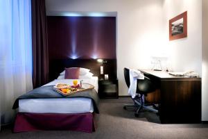 A bed or beds in a room at Hotel Turiec