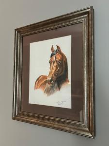 a painting of a horse in a frame on a wall at Warsaw Concept in Warsaw