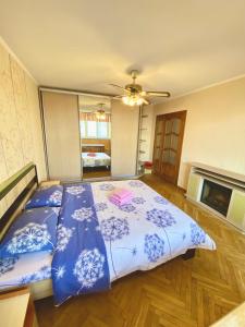 a bedroom with a bed with blue and white sheets at Апартаменти поруч з метро Лівобережна та МВЦ in Kyiv
