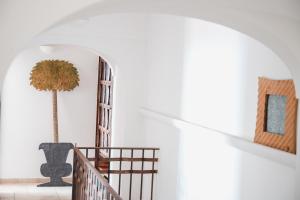 a staircase with a palm tree in a white wall at Villa Michika by Elite Villas in Capri