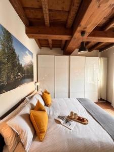 a bedroom with a bed with a large painting on the wall at CASA DI MILO in Cernobbio