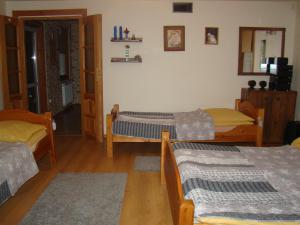 a room with three beds in a room at DOM POD LIPAMI in Wojsławice