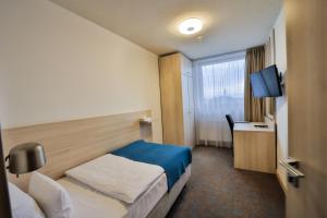 Posteľ alebo postele v izbe v ubytovaní Hotel Metropol