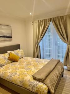 a bedroom with a bed and a window at No.8 - Garden Square in Banbury