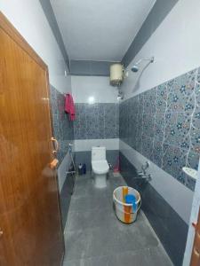a bathroom with a toilet and a sink at The Breezy Place in Chennai