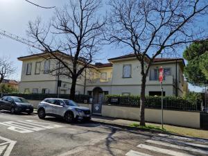 a white car parked in front of a house at Villa Sante Residence in Pesaro