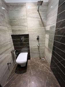 a bathroom with a toilet and a shower at Hotel SB Residency in Amritsar
