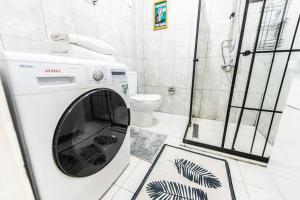 a washing machine in a bathroom with a shower at Best Location-Taksim Square Big and Modern Flat 140 (m2) 2+1 in Istanbul