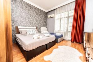 a bedroom with a bed with two towels on it at Best Location-Taksim Square Big and Modern Flat 140 (m2) 2+1 in Istanbul