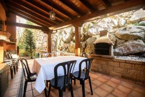 a dining room with a table and an outdoor oven at Vivienda Vacacional Eltxok in Llanes