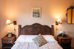 a bedroom with a wooden bed with two night stands at Vivienda Vacacional Eltxok in Llanes