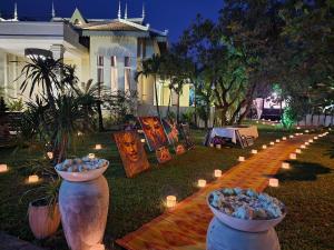 a garden with several large vases and lights in the grass at Sompoli Dthan in Siem Reap