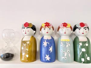 four glass figurines of nuns sitting on a shelf at ComeCasa 2 Bedrooms With Garden Apartment in Benevello