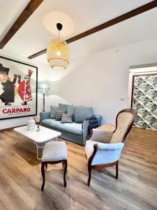 a living room with a couch and a table at ComeCasa 2 Bedrooms With Garden Apartment in Benevello