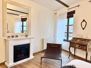 a living room with a fireplace and a mirror at ComeCasa 2 Bedrooms With Garden Apartment in Benevello