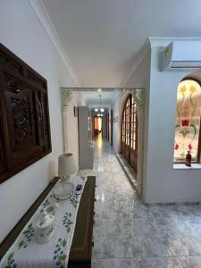 a room with a hallway with a table and a mirror at Marsaskala Sea Side Retreat in Marsaskala