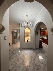 a large hallway with a chandelier in a house at Marsaskala Sea Side Retreat in Marsaskala