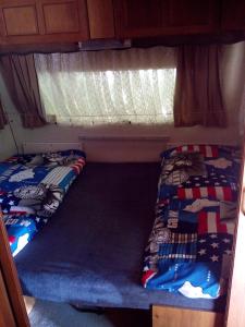 two beds in the back of an rv at Panelovka in Bítov