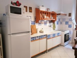 a kitchen with a white refrigerator and a microwave at Old Florence 1930 in Florence