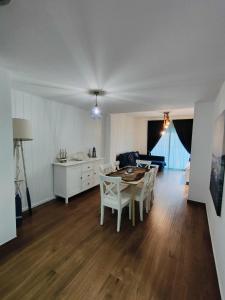 a kitchen and living room with a table and chairs at Sea you soon apartment. Lloret de Mar city center in Lloret de Mar