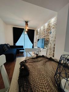 a living room with a bed and a stone wall at Sea you soon apartment. Lloret de Mar city center in Lloret de Mar
