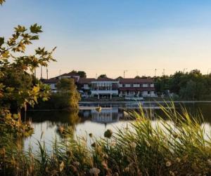 - un grand bâtiment à côté d'une étendue d'eau dans l'établissement Thrassa Hotel, à Tycherón