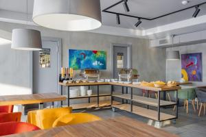 a kitchen with a table and some yellow chairs at Gogi Ski Resort in Gudauri