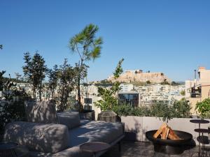 a patio with a couch and a view of the city at Monastik Living in Athina in Athens