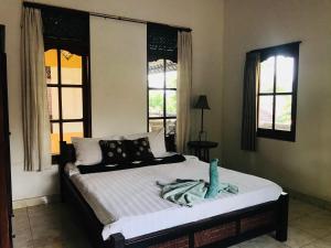 Кровать или кровати в номере Suastika Guest House