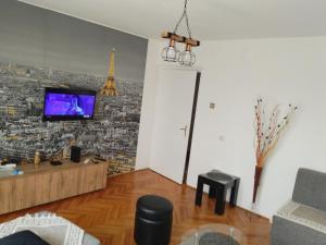a living room with a view of the eiffel tower at Apartman Petra in Leskovac