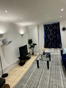 a living room with a couch and a tv at 2bed2 bath flat soho in London