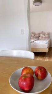 two apples on a plate on a table at Haus Olga in Hörbranz