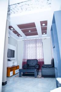 un salon avec un canapé et une table dans l'établissement Bwawani Gardens, à Songea 17 autres photos