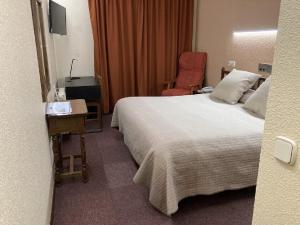 Postel nebo postele na pokoji v ubytování Hotel Folch