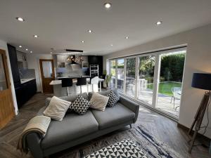 a living room with a couch with pillows on it at Stylish Modern Home with Parking Enclosed Garden in Holyhead