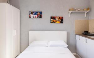 a bedroom with three pictures on the wall at Ran's Cozy Hotel Style apt in Tel Aviv