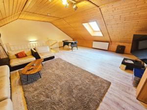 a living room with a couch and a table at Pimp My TLA-Ramstein House in Ramstein-Miesenbach