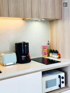 a kitchen with a counter top with a microwave at Panoramic sea homestay in Ha Long