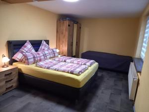 a bedroom with a bed with pillows on it at Ferienwohnung Am Wald in Catterfeld