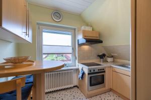 a small kitchen with a sink and a stove at Koch 2 in Dahme