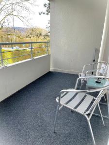 a chair sitting on a balcony with a view at Bina Familienapartment Trier in Trier
