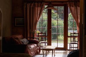 a living room with a large window and a couch at The Quarters in Strahan