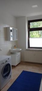 a kitchen with a washing machine and a sink at Jugendstilvilla voll renoviert in Falkenstein