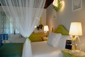 a bedroom with a bed with a white curtain at TEA HOUSE GERÊS in Geres
