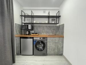 a kitchen with a washing machine and a sink at 1-комнатная квартира в самом центре города. Центральный парк in Petropavlovsk
