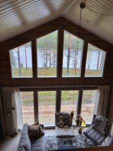 a living room with a large glass window at Villa Sol Del Luosto in Luosto