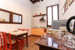 a kitchen with a table and chairs and a table and a kitchen at Flat with canal view near San Marco in Venice