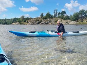 a man sitting in a kayak in the water at 4 person holiday home in ELL S in Ellos