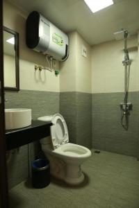 a bathroom with a toilet and a sink at Roxana Sapa Hotel - by Bay Luxury in Sa Pa